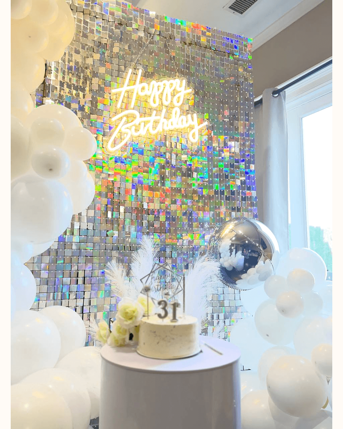 White balloon garland framing a shimmer wall