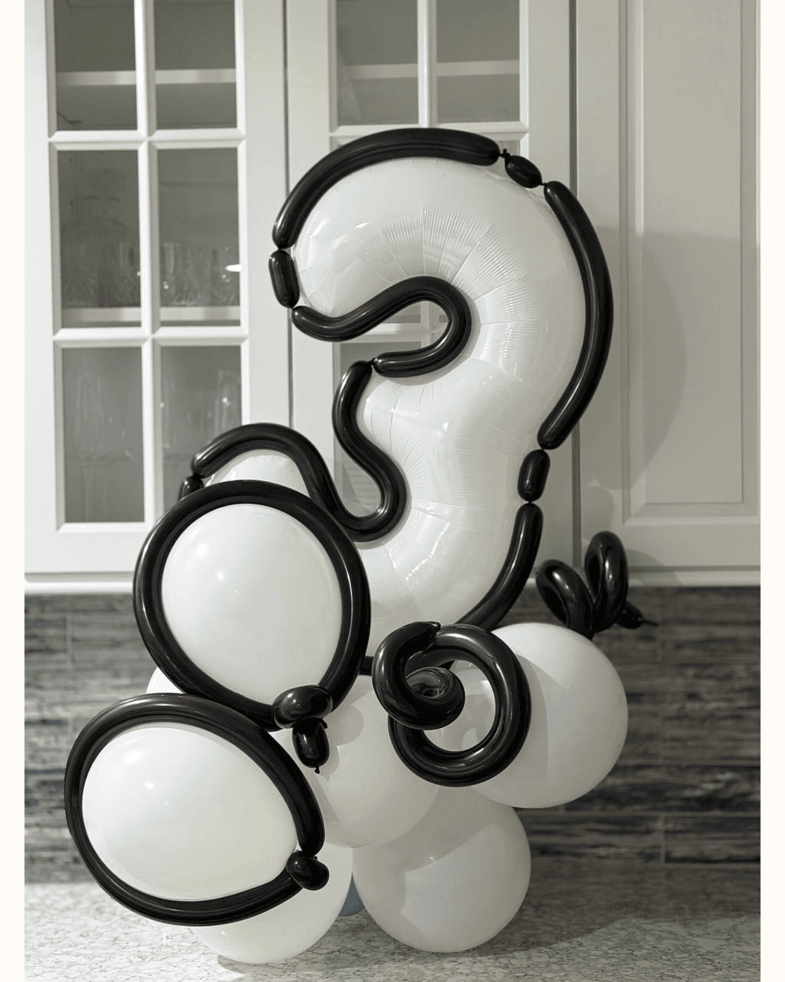 Modern black and white number three balloon sculpture